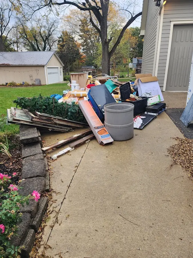 Dumpster being loaded with debris for Roofing Dumpster Rental in Hidden Springs